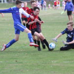 Ripon's goalkeeper gets to the ball just ahead of Matthew Hill